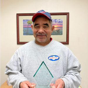 Jose poses with an Aspire Award trophy.