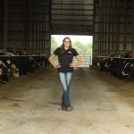 Maryann poses in a barn at her work.